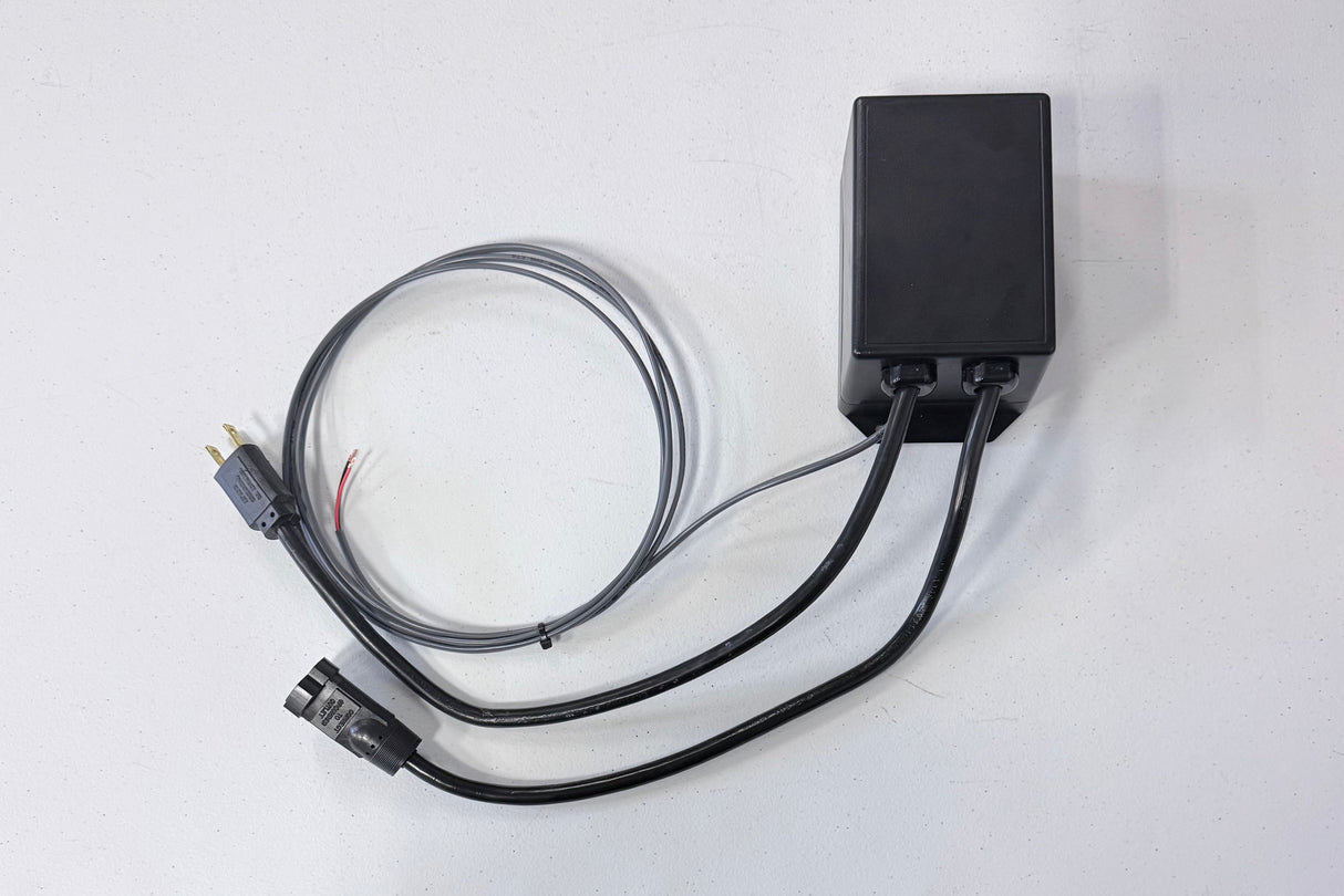 Black electronic device with cables on a white background