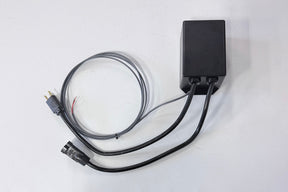 Black electronic device with cables on a white background