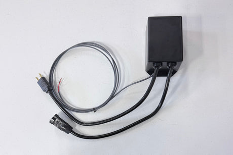 Black electronic device with cables on a white background